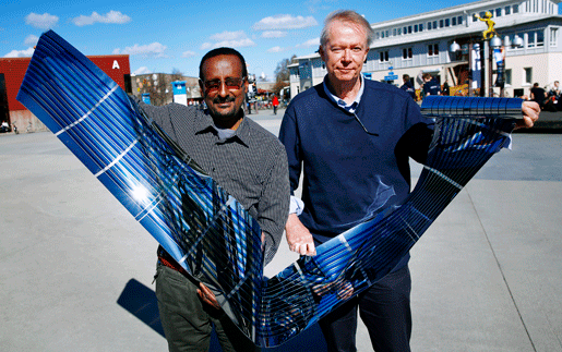 Image: Researchers Olle Inganäs and Shimelis Admassie demonstrate solar cells on a roll. Photo: Stefan Jerrevång